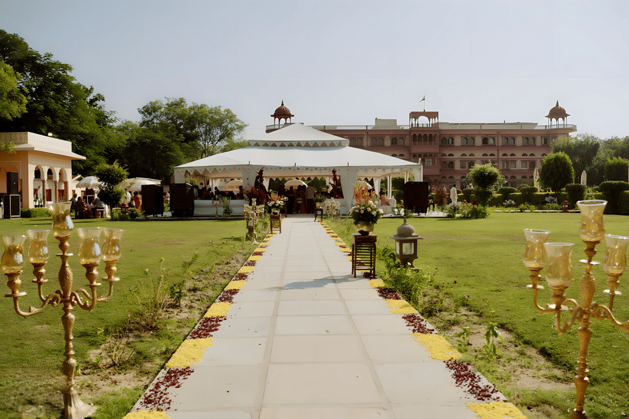Outdoor pathway with floral decor leading to venue at Umaid Palace for Charvi & Dhruv wedding.