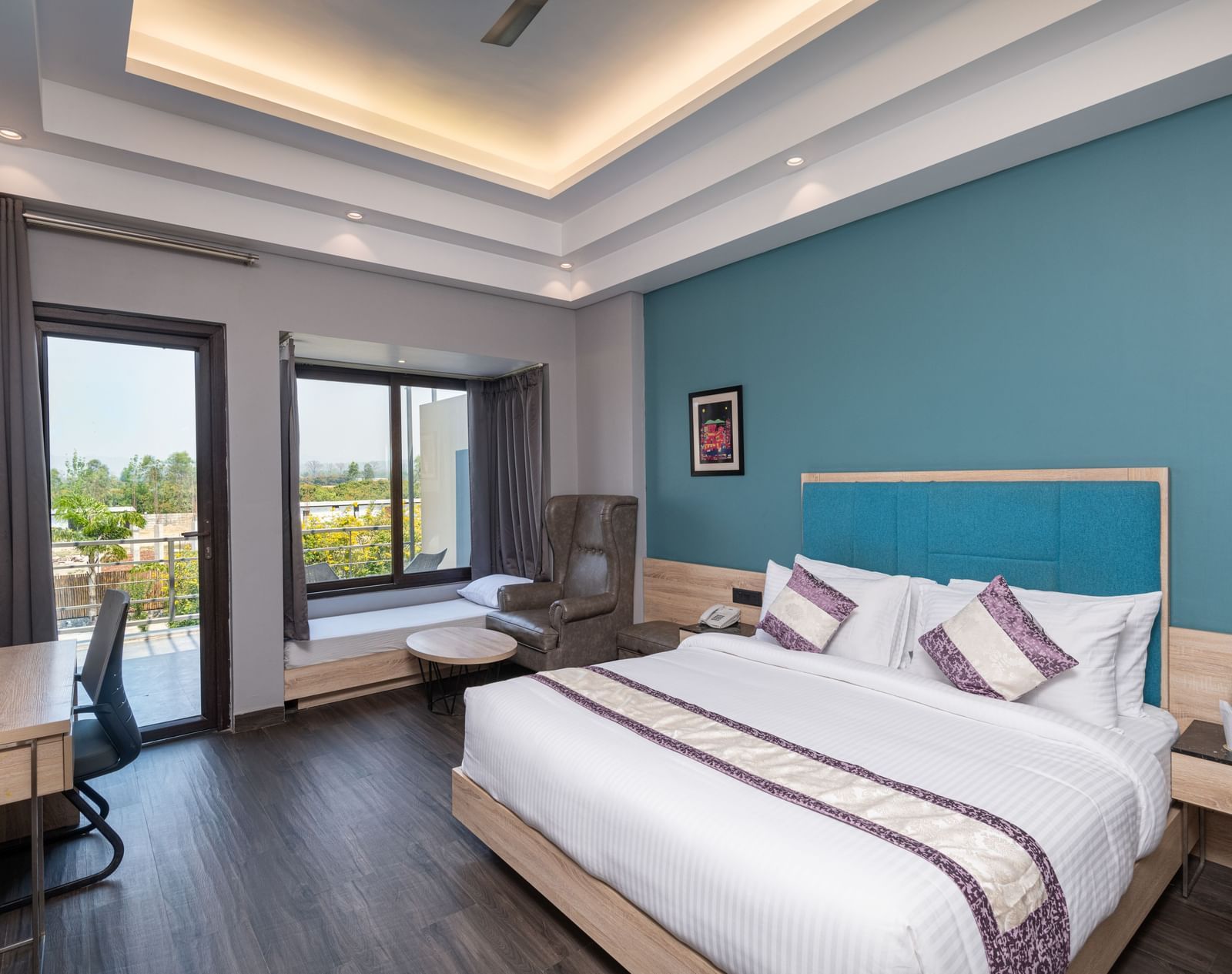 Bedroom with modern furnishings and access to a scenic balcony - DLS Forest Vines Resort & Spa, Ramnagar (Jim Corbett)