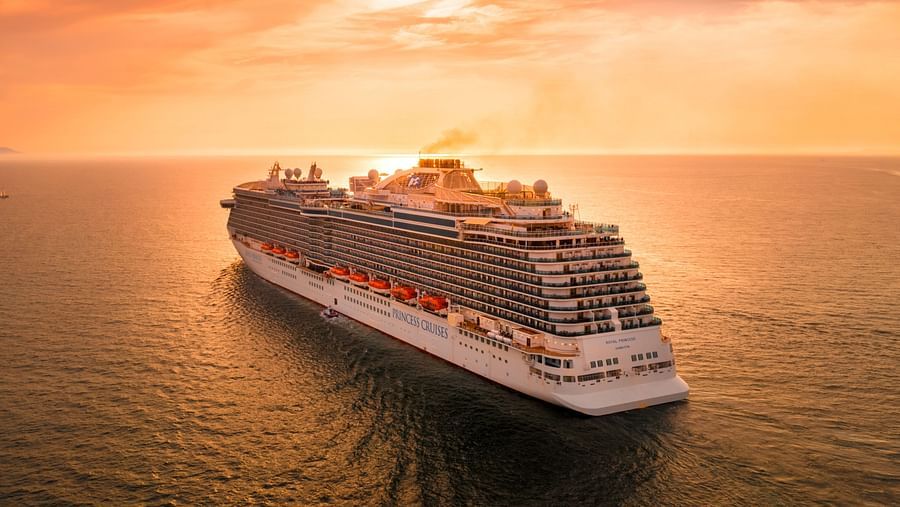 A cruise ship sailing towards the sunset
