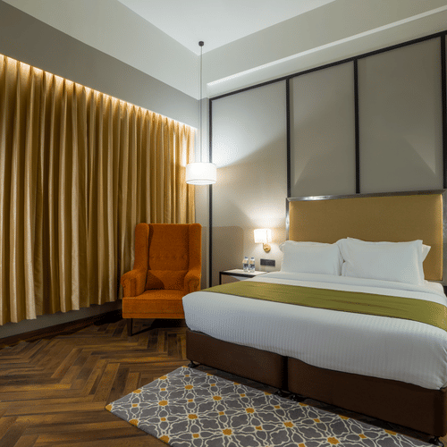 double bed in one of the rooms at Polo Hotel Agartala