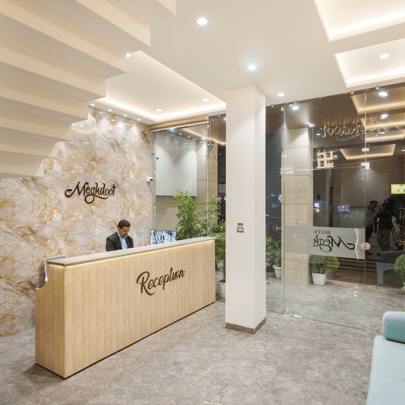 A person standing at the reception area of Hotel Meghdoot, Bhopal