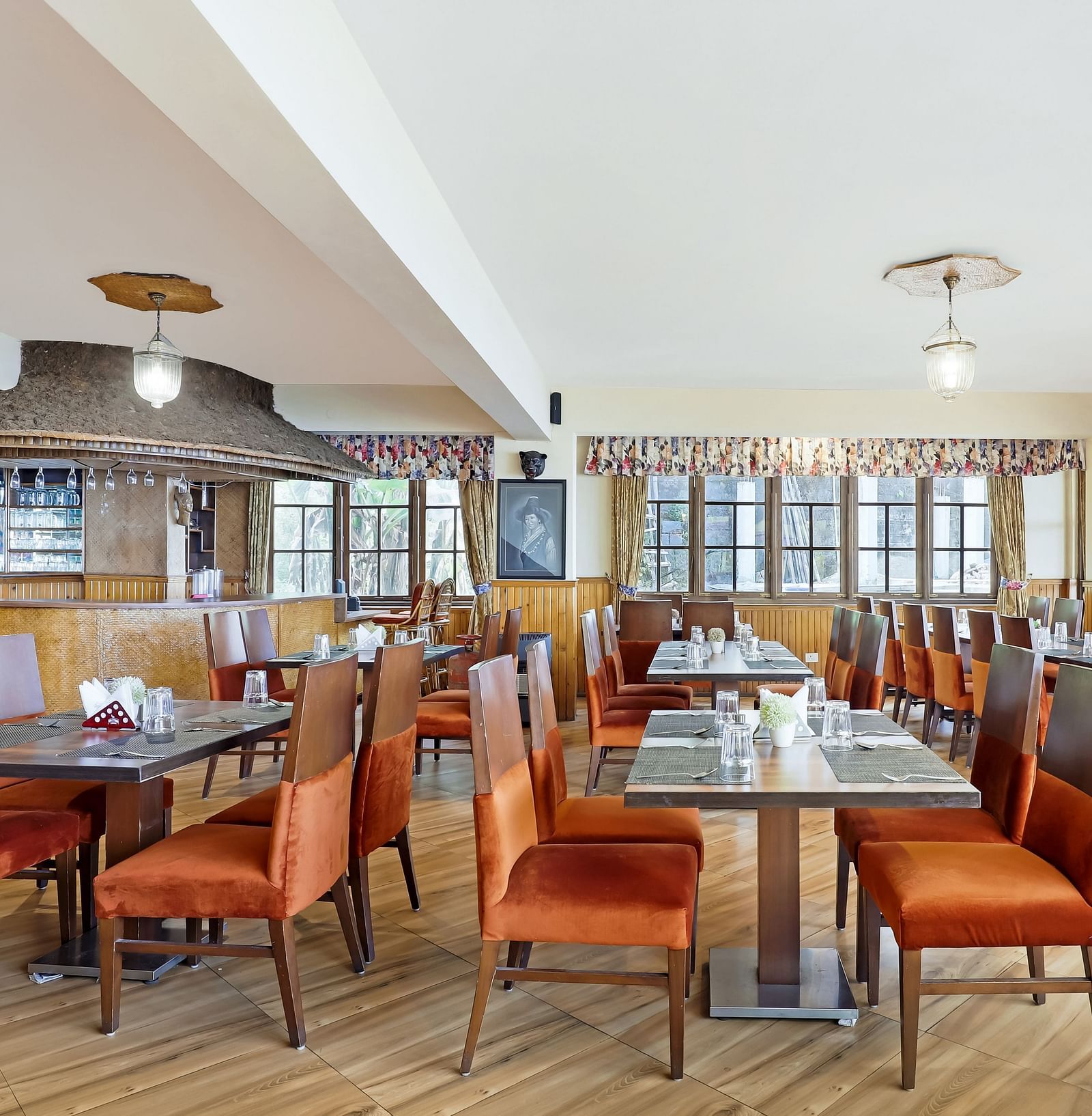 A side view of dining tables and chairs in a closed dining space | Summit Newa Regency & Spa, Pelling