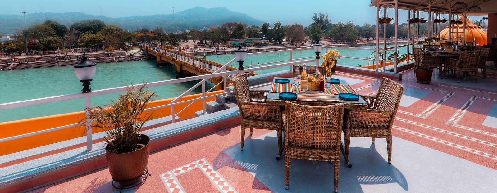  A romantic dinner setup on a riverboat, with a view of the illuminated river.