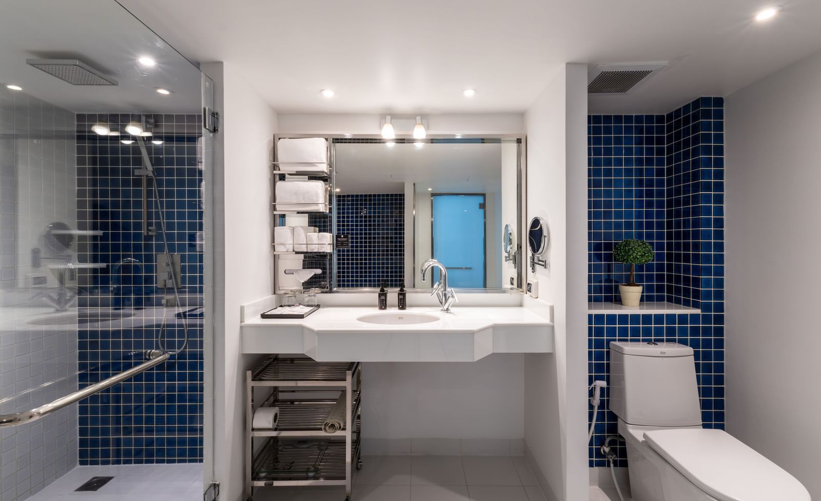 Modern bathroom at Night Hotel Bangkok with large mirror and sleek design.