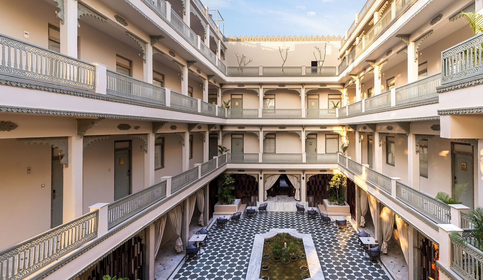 An overview of a courtyard with the inside of the building in view - Manuscript - Jhilwara Haveli, Udiapur