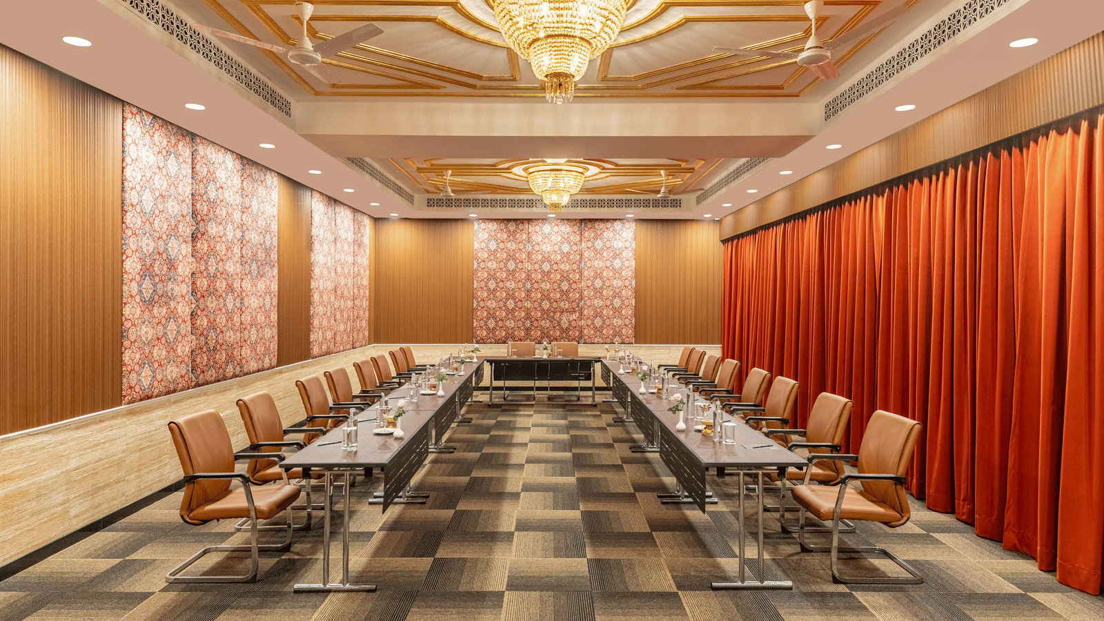 Elegant boardroom with chandelier and wooden seating at MAYFAIR Palm Beach Resort, Gopalpur-on-Sea