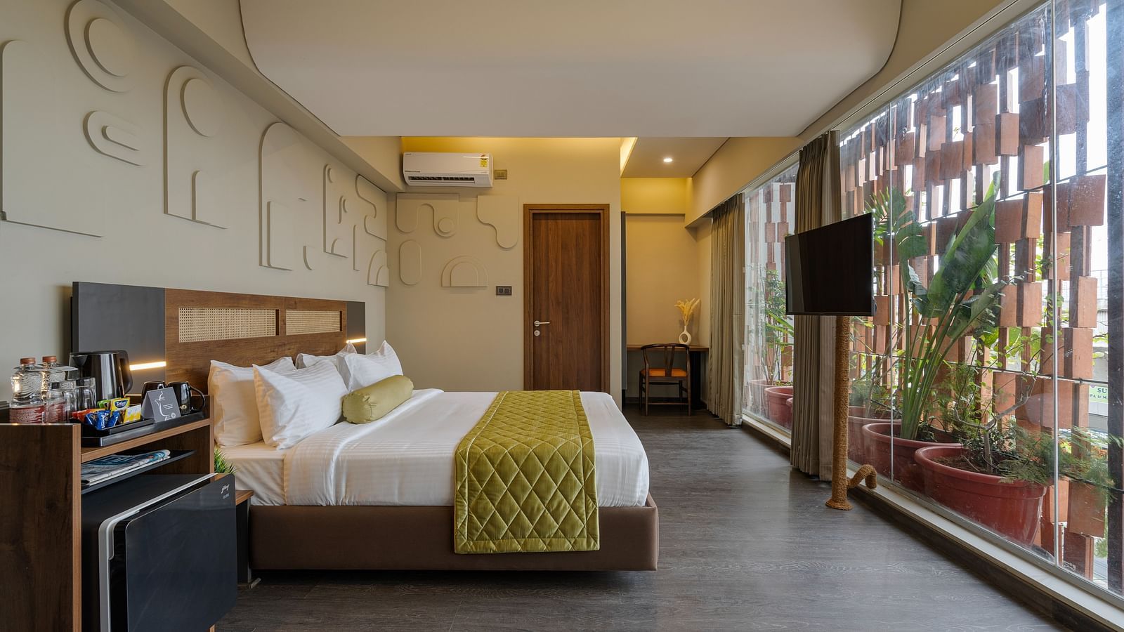 Tangelos Room at Fressotel, Kanakapura Road, with a 360 sq. ft. space, a king-sized bed and a wall mounted flat tv.