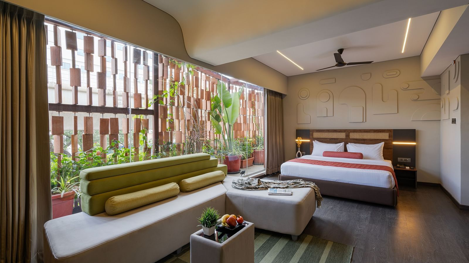 Comfortable Room with ample sunlight and a plush bed. The room aslo features a relaxing six seater sofa, perfect for both business and leisure travelers.