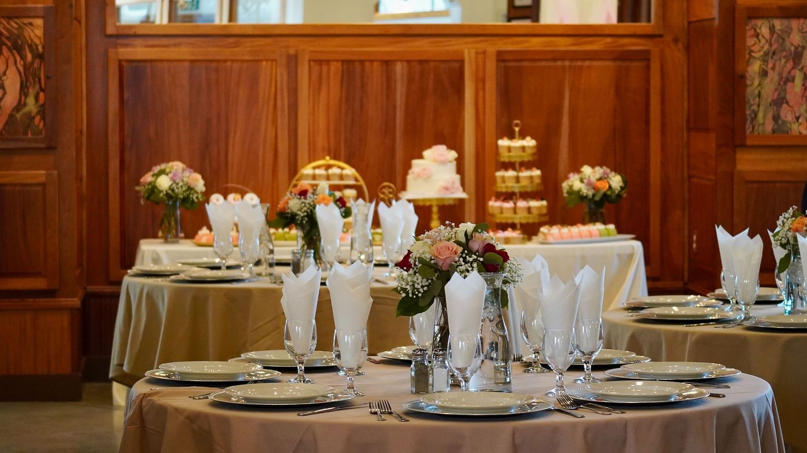 image of a round table in a banquet hall with well arranged cutlery and napkins