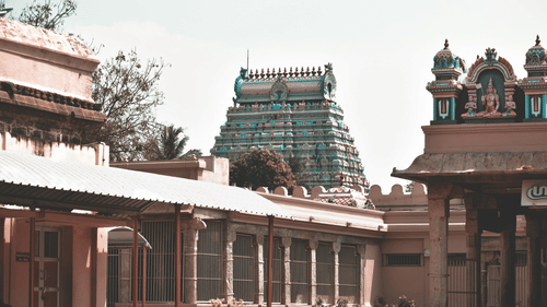 An overview of a temple in South India with intricate architecture on its roof.