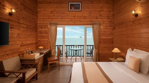 A view of the balcony offering views of the ocean seen from inside of a room in Sindhudurg - Highland Sarovar Portico, Sindhudurg