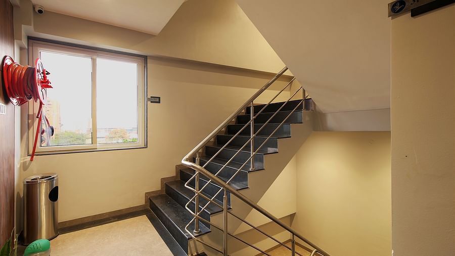 Stair case with a water hose in view - Magnus Fortune House, Magarpatta