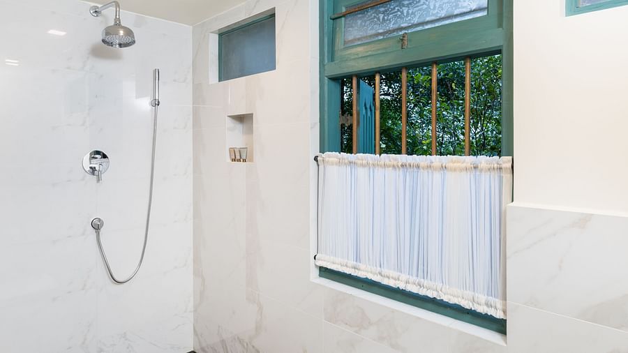 A contemporary shower area with white tiles, large windows, and ample natural light creating a refreshing space - Heavensa Villas and Suites by the Clarks, Galle