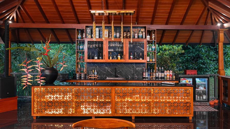  A stylish indoor bar area featuring a large bar counter, filled with decorative bottles, and sophisticated lighting creating a cosy ambience - Heavensa Villas and Suites by the Clarks, Galle