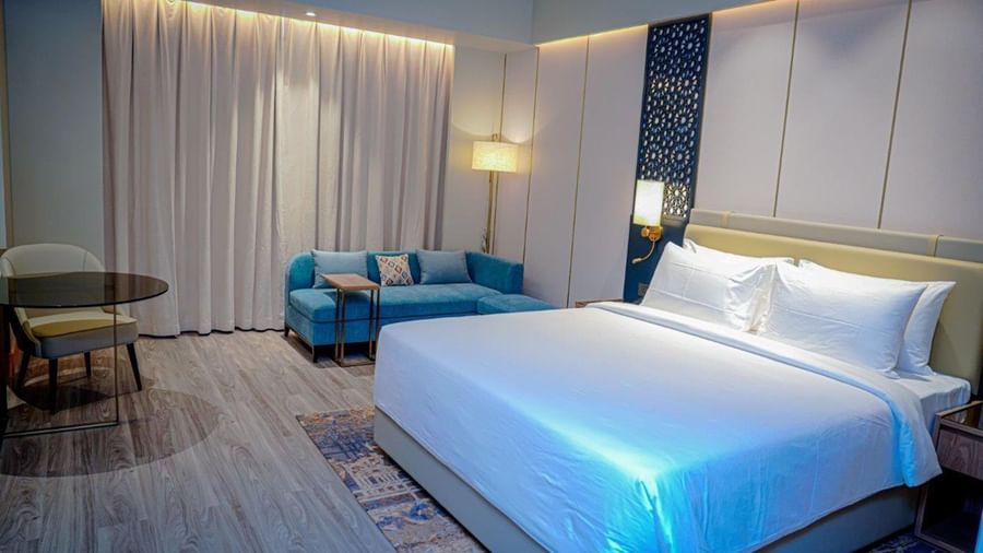 Deluxe Room of our hotel near Hargeisa featuring a double bed, a couch, and a work desk - Serene Sarovar Premiere Hargeisa