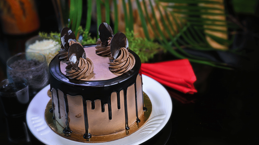 A cake placed on a plate at a dining space at Clarks Hotels.