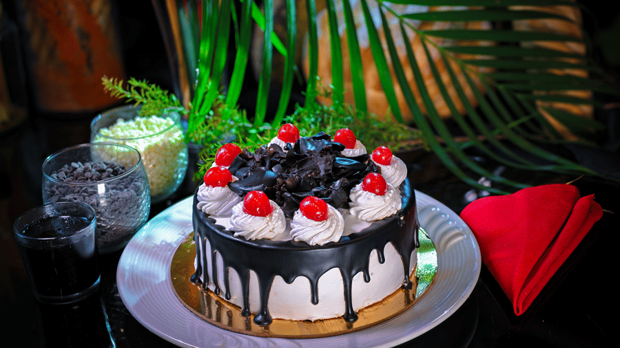 A cake placed on a plate at a dining space at Clarks Hotels.