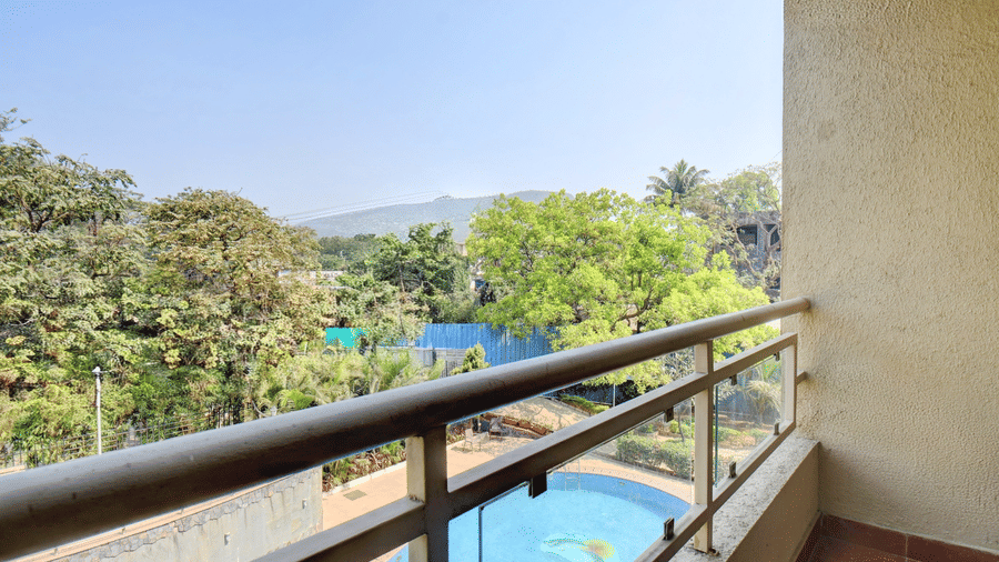Private balcony with railing and scenic greenery view at VITS Lonavala.