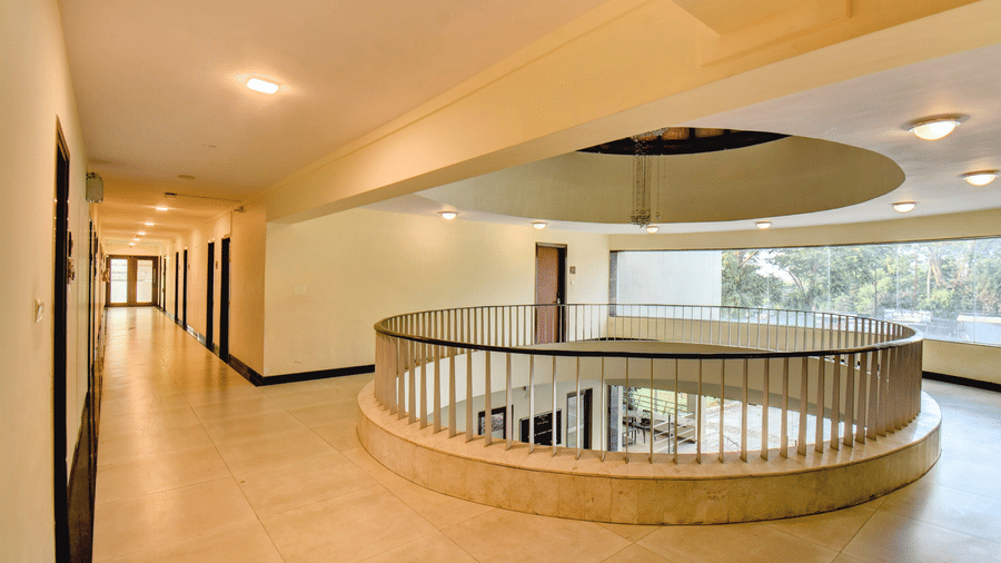 Spacious upper floor corridor with circular atrium railing at VITS Lonavala.