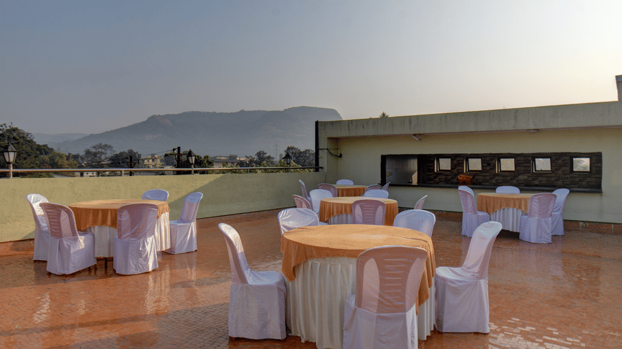 Open-air terrace event space with decorated tables and mountain views at VITS Lonavala.