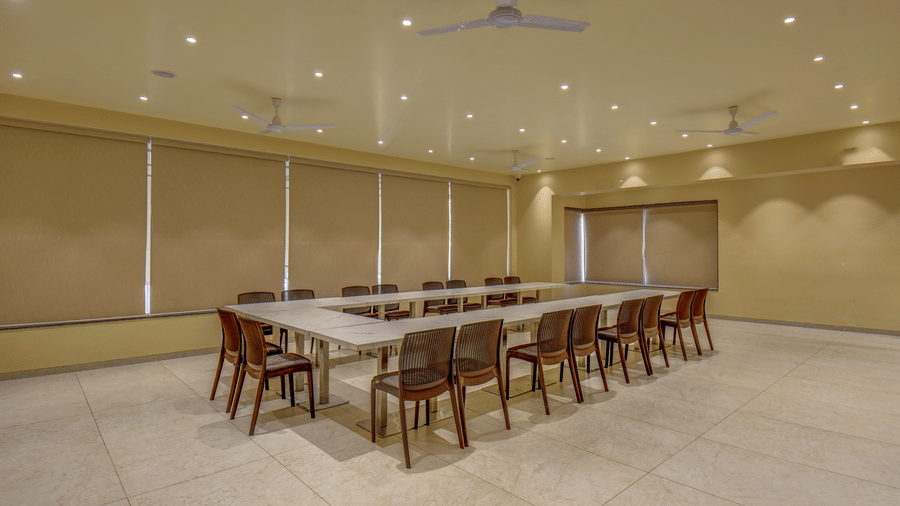 Spacious meeting room with a long conference table and chairs arranged at VITS Select Nashik Hotels & Resorts