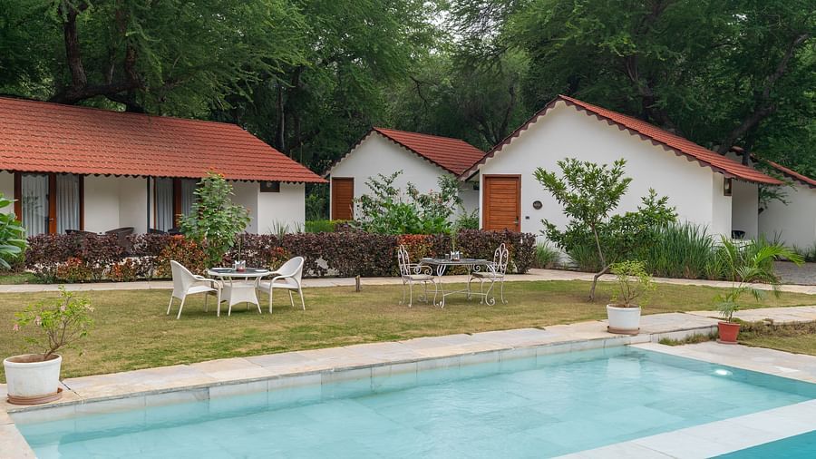 image of the swimming pool from the corner with sating area at the pool side