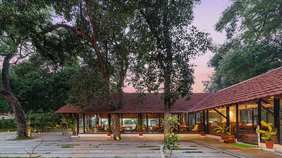 facade image of the lobby right after the entrance in an evening setting at aranya vilas