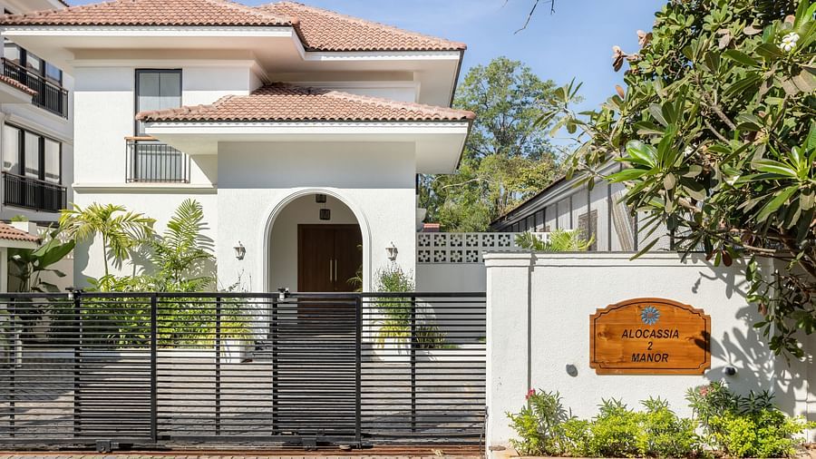 The exterior of a modern villa with a gated entrance, landscaped greenery, and elegant architectural features - BluSalzz Villas - Alocassia, Anjuna