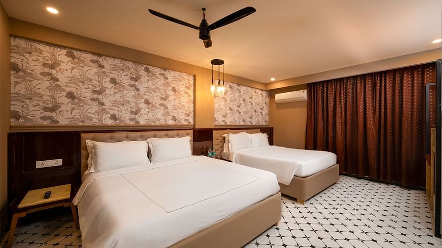 An image of a chic room with large windows, allowing natural light to fill the space at Crescent Resort, Goa.