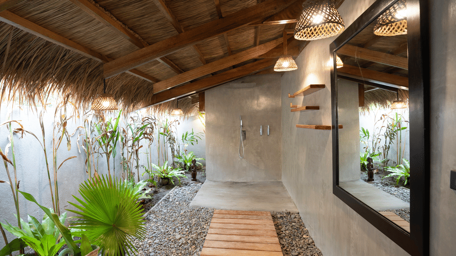 A bathing space with a floating shower head, lights, and plants at Flower Island Resort.
