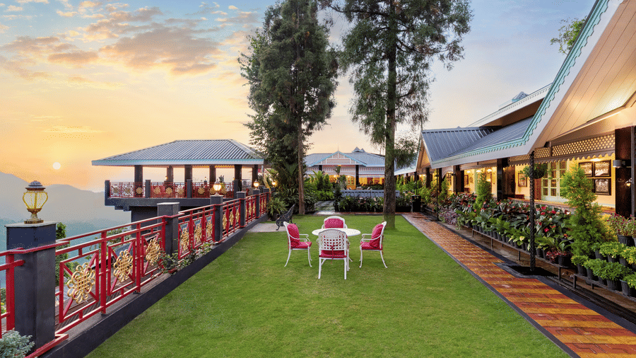 Garden lawn terrace with outdoor seating overlooking hills at sunset, Mayfair Manor, Jungpana.