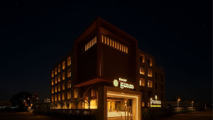  Exterior view of Pravasa Hotel at night with illuminated windows | Pravasa Hotel, Vijayapura