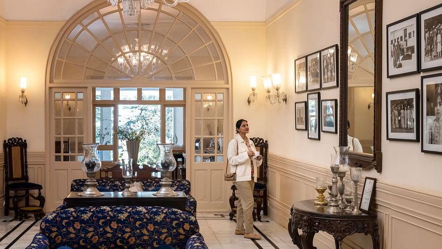 image of a brightly lit lobby with a person admiring the photo wall on the right