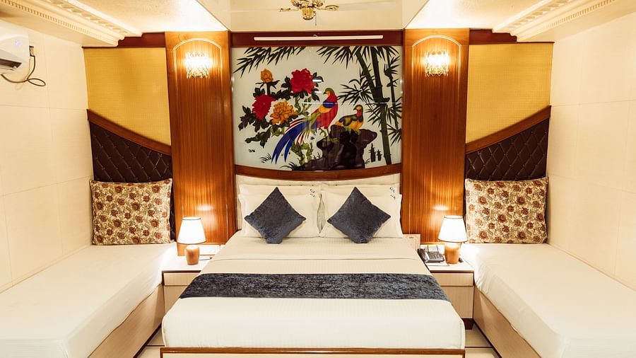 image of the grand suite featuring a double bed with a beautiful painting above the headboard at The Grand Krishna Rooms, Bengaluru