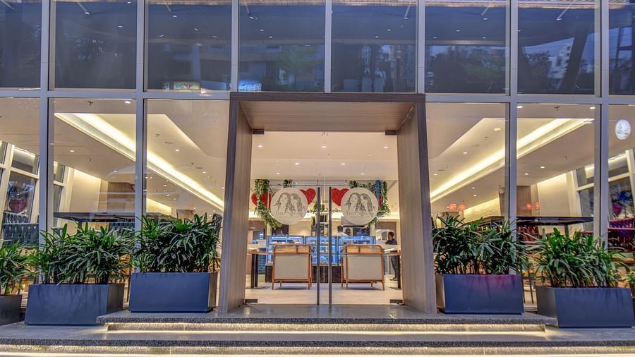 Entrance of two sister's cafe The SSK Solitaire Boutique Hotel & Spa, Gangapur Road - Nashik surrounded by plants.