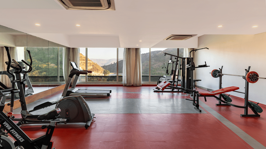 A gym neatly arranged with exercise equipment featuring facilities of Via Lakhela Resort & Spa