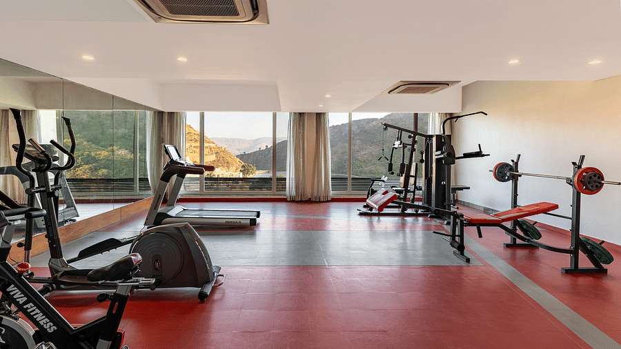 A gym neatly arranged with exercise equipment - Via Lakhela Resort & Spa