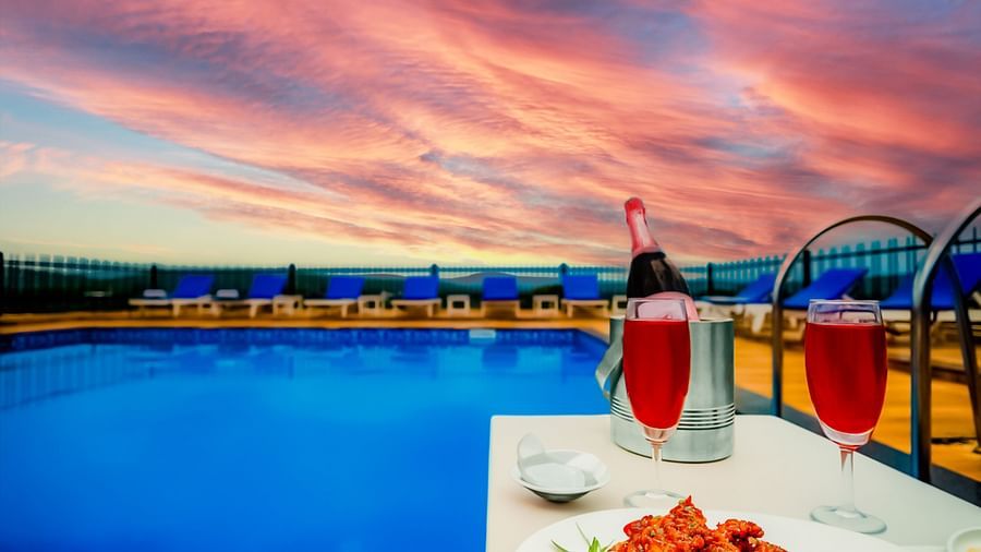 Swimming pool with drinks on the side at Vagator Downtown, Goa