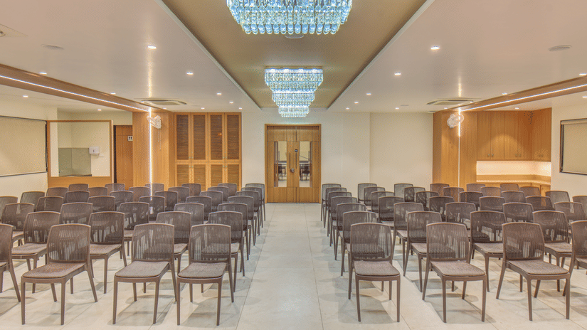 Ballroom at VITS Select Nashik Hotels & Resorts featuring a classroom seating arrangement with chairs lined up under warm lighting