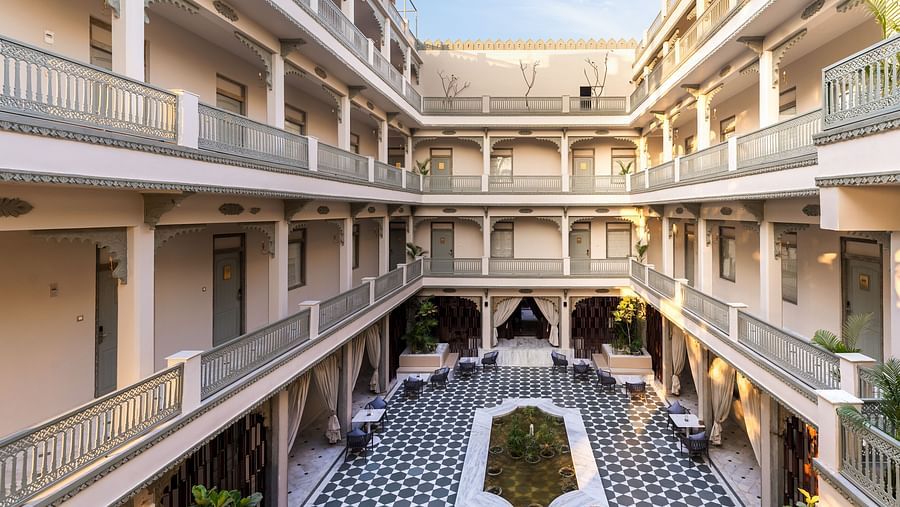 An overview of a courtyard with the inside of the building in view - Manuscript - Jhilwara Haveli, Udiapur