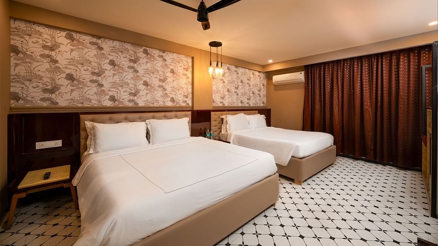 An image of a chic room with large windows, allowing natural light to fill the space at Crescent Resort, Goa.