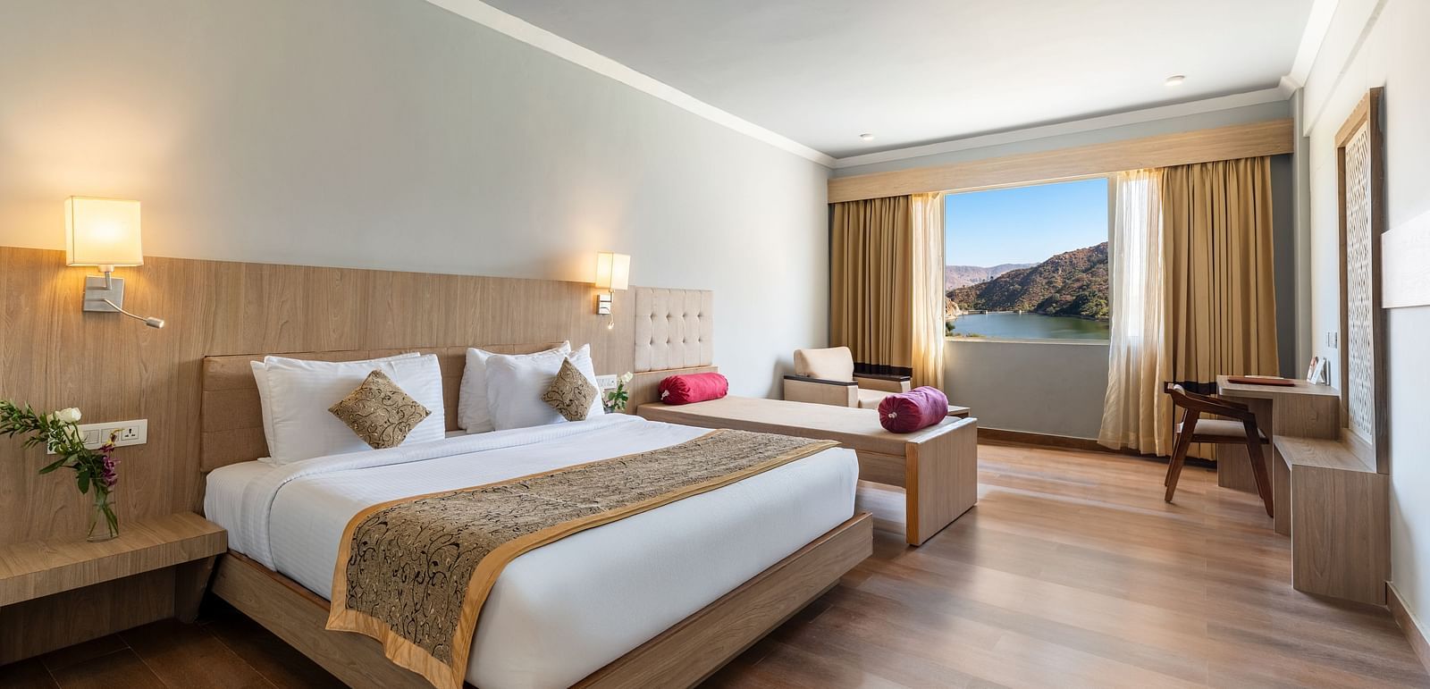 A wide angle shot of a room with a large bed neatly arranged with a patterned runner on it - Via Lakhela Resort & Spa, Kumbhalgarh