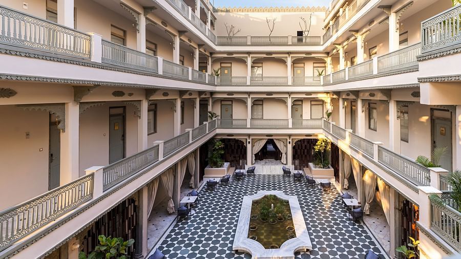 An overview of a courtyard with the inside of the building in view - Manuscript - Jhilwara Haveli, Udiapur