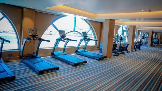 The treadmills in a Hargeisa gym placed in front of a window offering a view - Serene Sarovar Premiere Hargeisa