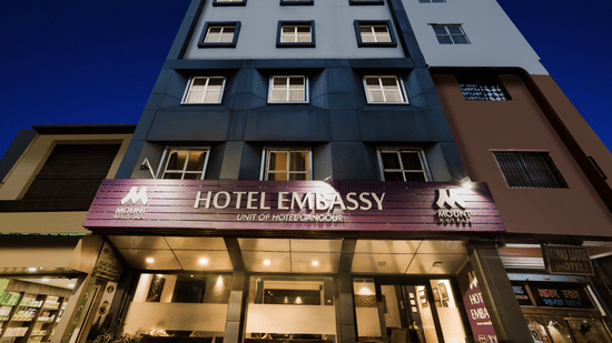 Mount Embassy Hotel in Siliguri with illuminated signage and structured facade.