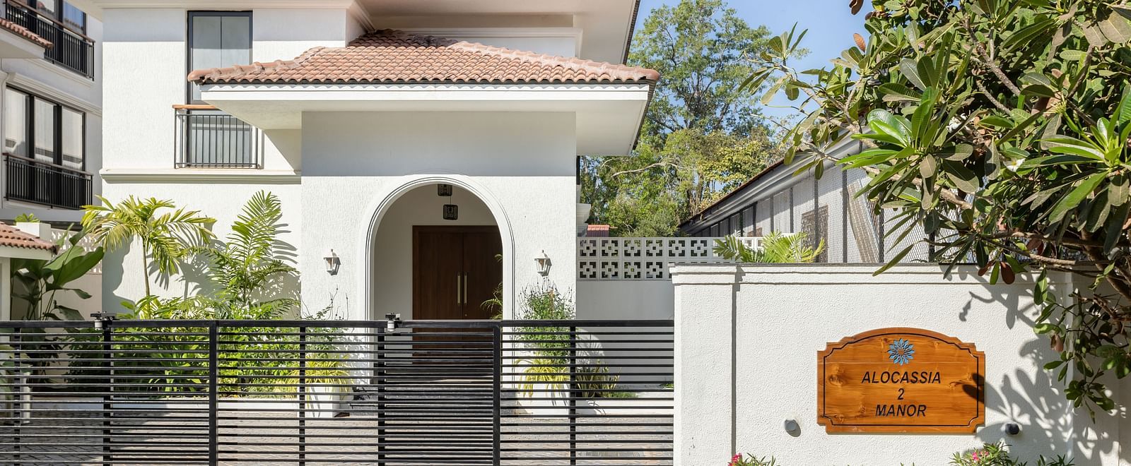 The exterior of a modern villa with a gated entrance, landscaped greenery, and elegant architectural features - BluSalzz Villas - Alocassia, Anjuna
