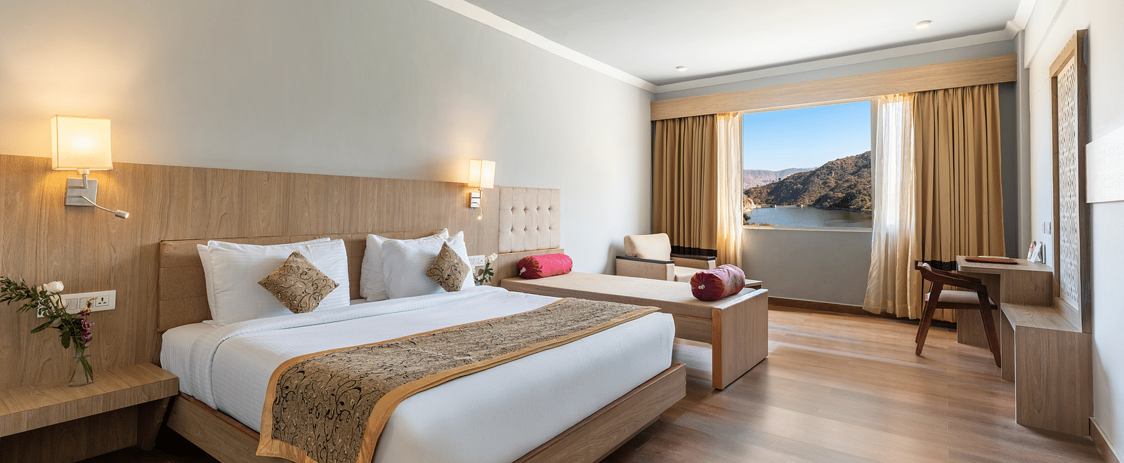 A wide angle shot of a room with a large bed neatly arranged with a patterned runner on it - Via Lakhela Resort & Spa, Kumbhalgarh