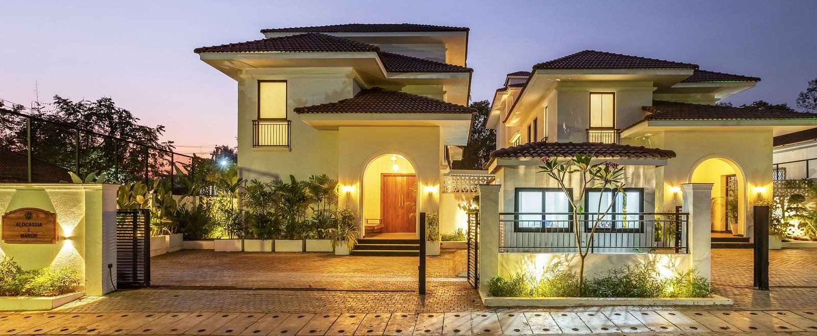 A wide-angle view of a luxury villa at twilight, highlighting its contemporary design and well-maintained facade - BluSalzz Villas - Alocassia, Anjuna