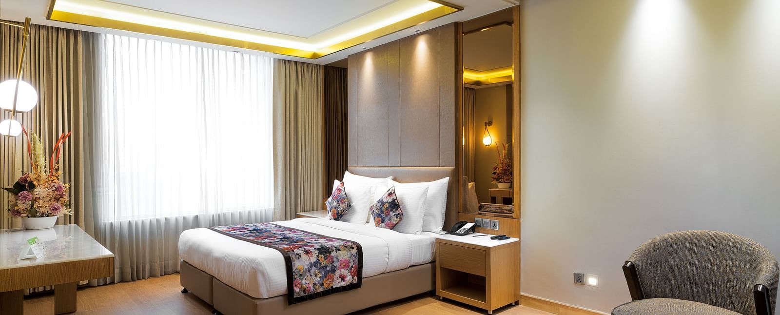The Club Room at Nirvana Luxury Hotel, Ludhiana with a single bed and a television.