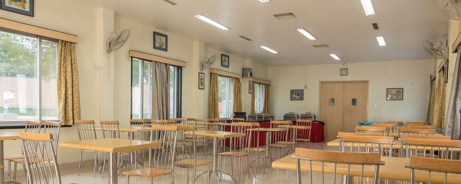 The conference room shown from a different angle, highlighting the large windows and serene decor at Shantiniketan - Budget Stay in Hyderabad near Ramoji Film City.